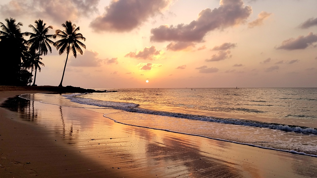 Sunset over calm sea at Ghoghla with pink and gold sky