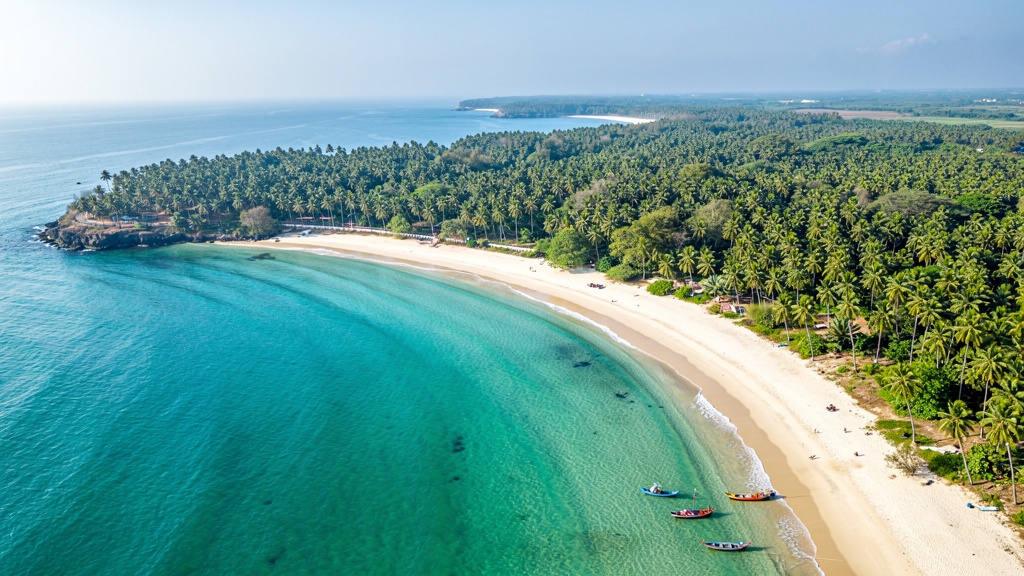 Aerial view of Nagoa's perfect horseshoe bay ringed by green Hoka palms